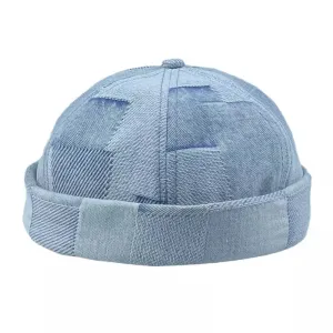 Camden Patchwork Denim Docker Cap boater hat with bow in beach sunlight