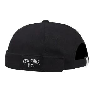 New York NY Black Docker Cap boater hat with bow in beach sunlight