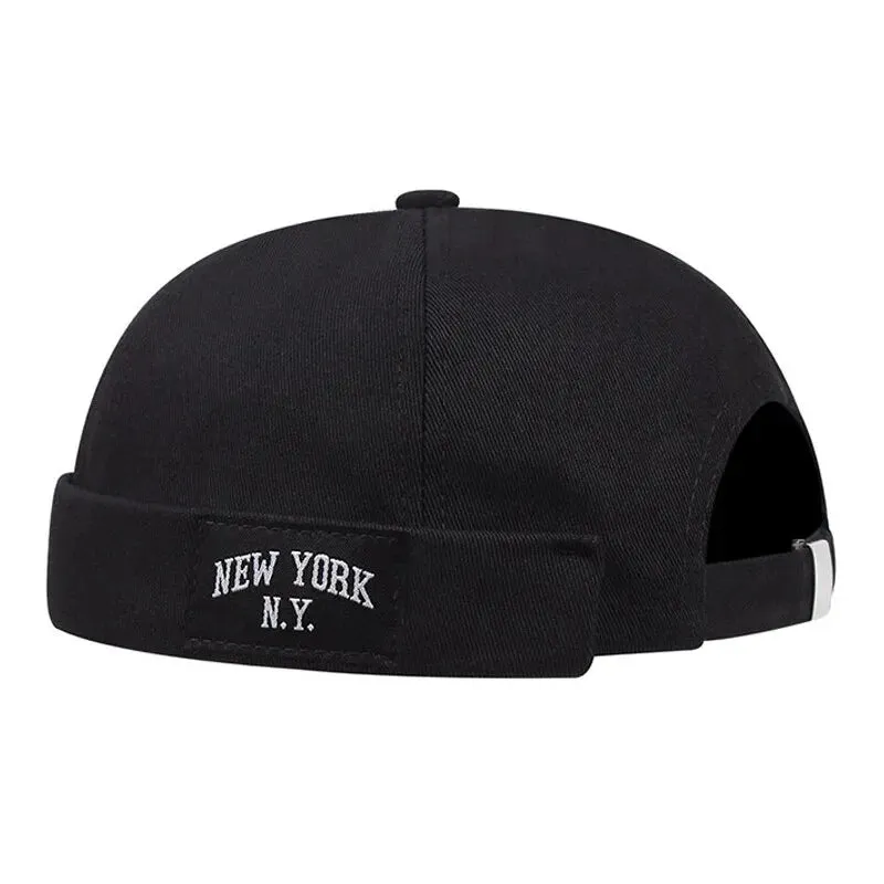 New York NY Black Docker Cap boater hat with bow in beach sunlight